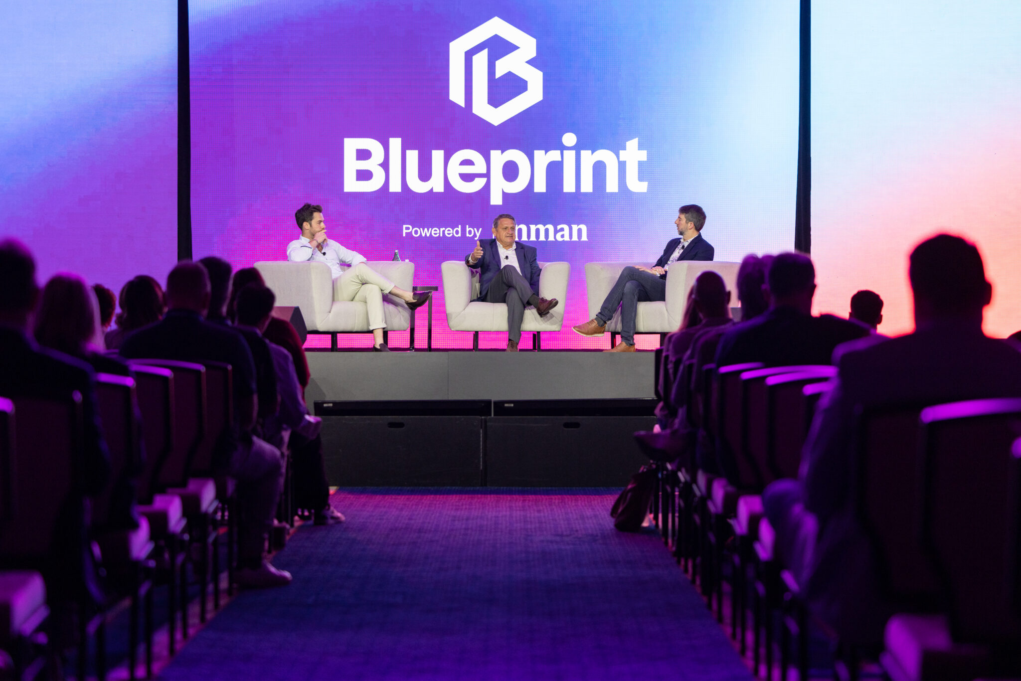 Panel discussion on the Blueprint 2026 main stage, with attendees in the foreground.